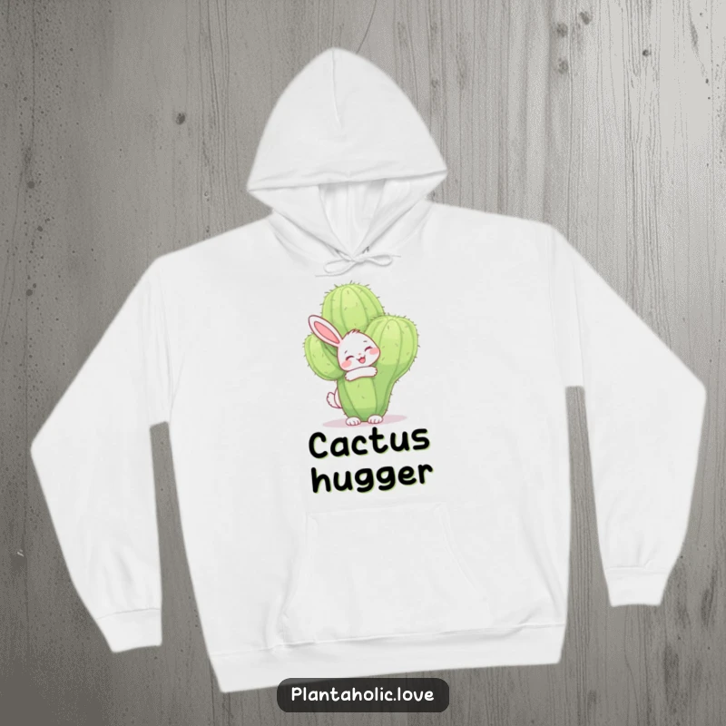 Funny bunny hoodie featuring a cheerful bunny joyfully hugging a large, fuzzy cactus with a smile, radiating warmth and affection.